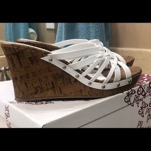 Pair of white and  kork heel  sandals.